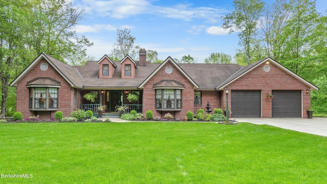 5 Victoria Ln, Lanesborough, MA 01237 - view of front facade with covered porch, brick siding, a front yard, a garage, and driveway