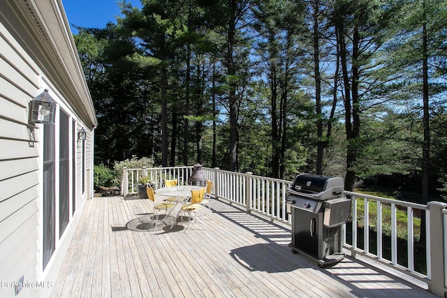 wooden deck with a grill