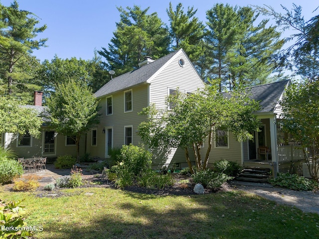 rear view of house featuring a yard and a patio