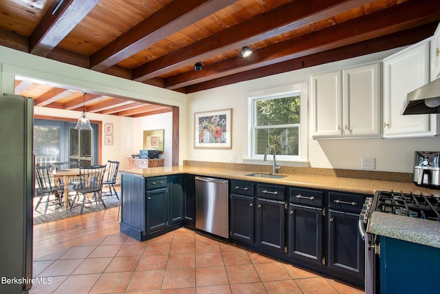 kitchen with beam ceiling, white cabinetry, sink, stainless steel appliances, and decorative light fixtures