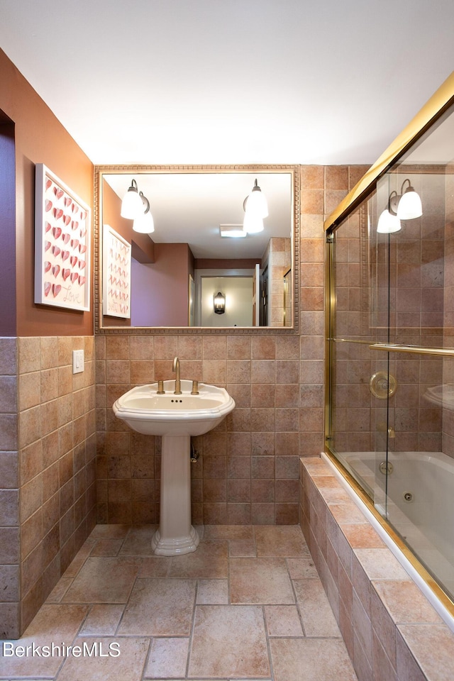 bathroom with enclosed tub / shower combo and tile walls