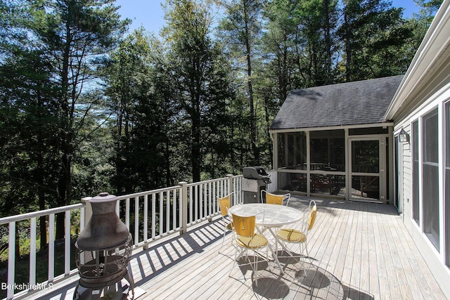 wooden terrace featuring a sunroom