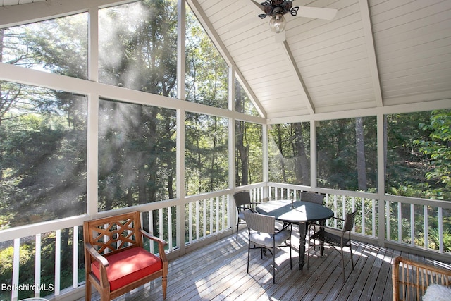 sunroom featuring ceiling fan, a healthy amount of sunlight, and lofted ceiling