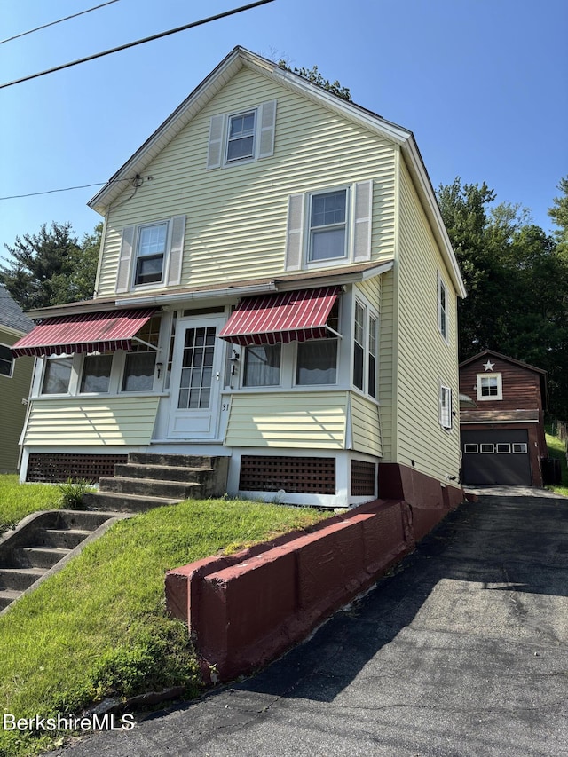 31 Millard Ave, Clarksburg, MA 01247 - view of front of house featuring entry steps, a detached garage, and an outbuilding