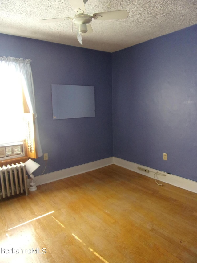31 Millard Ave, Clarksburg, MA 01247 - empty room featuring radiator, wood finished floors, a ceiling fan, and a textured ceiling