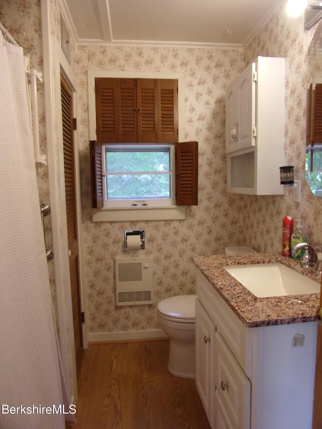 31 Millard Ave, Clarksburg, MA 01247 - bathroom featuring wood finished floors, heating unit, vanity, wallpapered walls, and ornamental molding