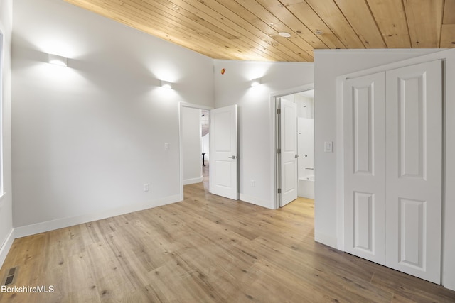 unfurnished bedroom with ensuite bathroom, light wood-style floors, wooden ceiling, lofted ceiling, and visible vents