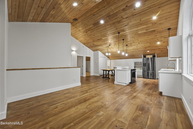 kitchen with a center island, a sink, wood ceiling, stainless steel fridge with ice dispenser, and light countertops