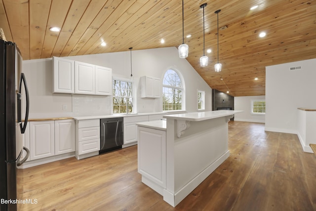 kitchen with wood ceiling, stainless steel appliances, light countertops, and visible vents