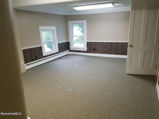 406 Main St, Great Barrington, MA 01230 - unfurnished room featuring baseboard heating, wainscoting, and carpet floors