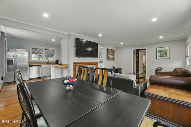 24 Henderson Rd, Williamstown, MA 01267 - dining area featuring light wood-style flooring, a fireplace, ornamental molding, and recessed lighting