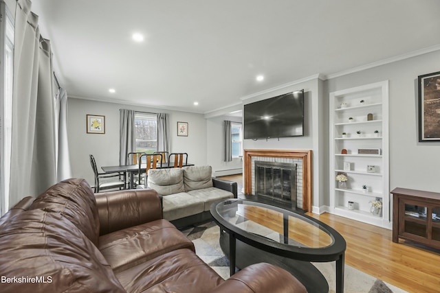 24 Henderson Rd, Williamstown, MA 01267 - living area featuring ornamental molding, built in features, light wood finished floors, and baseboard heating