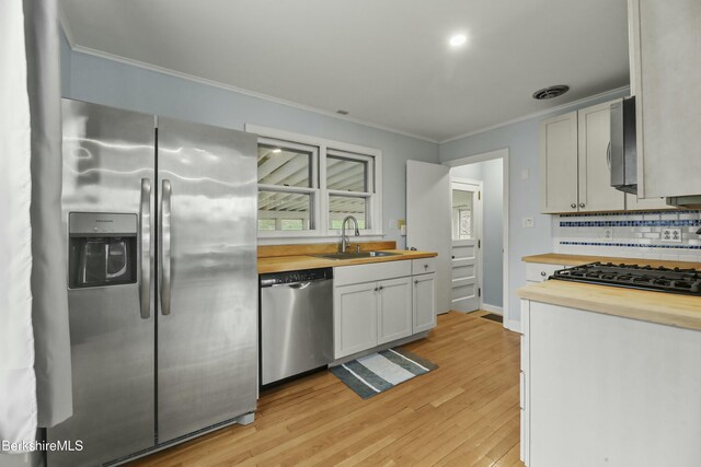 24 Henderson Rd, Williamstown, MA 01267 - kitchen with a sink, butcher block counters, crown molding, and stainless steel appliances