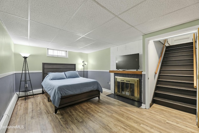 24 Henderson Rd, Williamstown, MA 01267 - bedroom with baseboard heating, a drop ceiling, baseboards, and wood finished floors