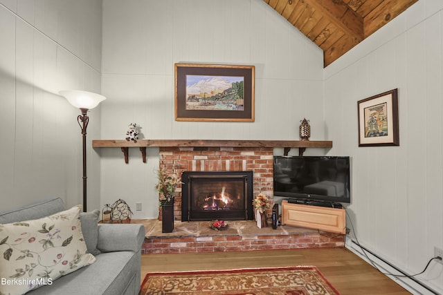 545 Leisure Lee Rd, Lee, MA 01238 - living area with wood finished floors, a baseboard heating unit, a brick fireplace, and wooden ceiling