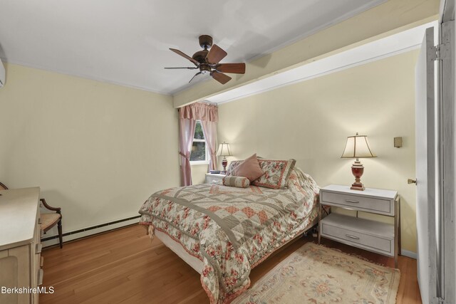 545 Leisure Lee Rd, Lee, MA 01238 - bedroom with a baseboard radiator, wood finished floors, a ceiling fan, and ornamental molding