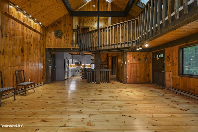 377 Highland Way, Sandisfield, MA 01255 - unfurnished living room featuring high vaulted ceiling, wood walls, hardwood / wood-style flooring, a wooden ceiling with exposed beams, and a baseboard heating unit
