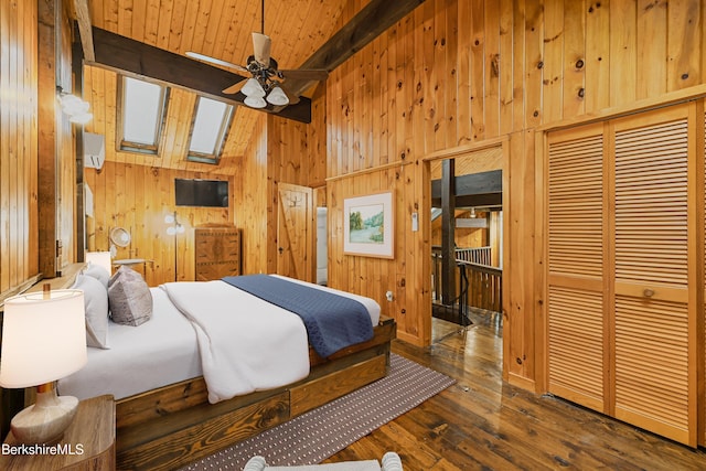 377 Highland Way, Sandisfield, MA 01255 - bedroom with wood walls, hardwood / wood-style floors, beam ceiling, a skylight, and a closet