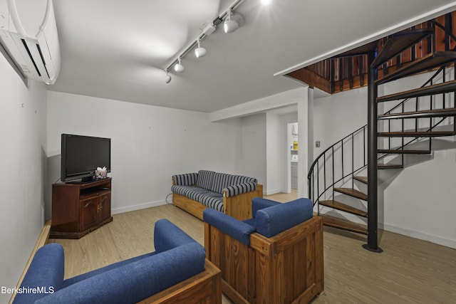 377 Highland Way, Sandisfield, MA 01255 - living room featuring an AC wall unit, wood finished floors, rail lighting, and stairway