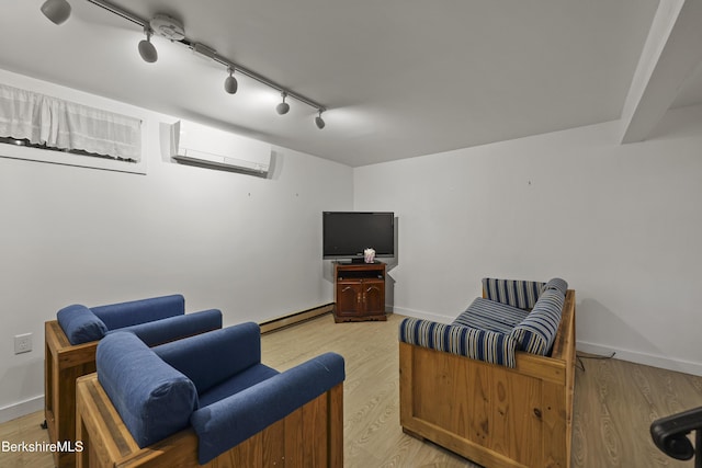 377 Highland Way, Sandisfield, MA 01255 - living room featuring light wood-type flooring, rail lighting, a wall mounted air conditioner, and a baseboard radiator