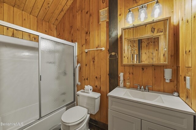 377 Highland Way, Sandisfield, MA 01255 - bathroom featuring vanity, shower / bath combination with glass door, wood walls, and vaulted ceiling