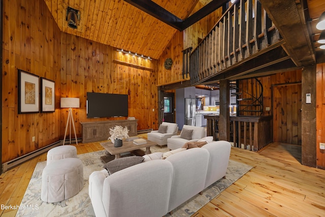 377 Highland Way, Sandisfield, MA 01255 - living room with hardwood / wood-style floors, wood walls, a baseboard heating unit, high vaulted ceiling, and stairs