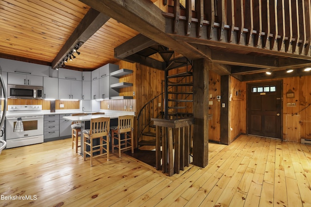 377 Highland Way, Sandisfield, MA 01255 - kitchen featuring white range with electric cooktop, stainless steel microwave, light countertops, light wood-style flooring, and a wood ceiling with exposed beams
