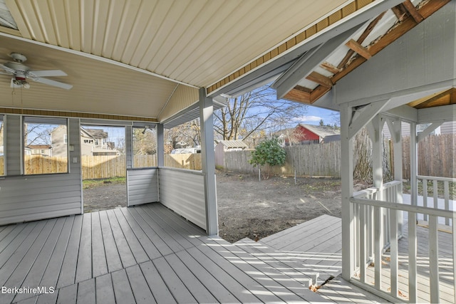 wooden deck featuring ceiling fan and a fenced backyard