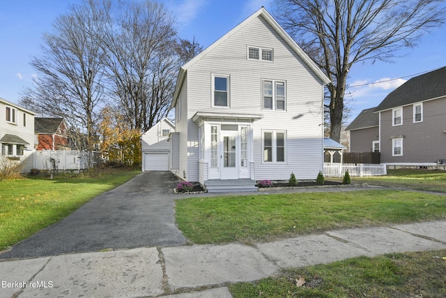 view of front of home with a garage, a front yard, and fence