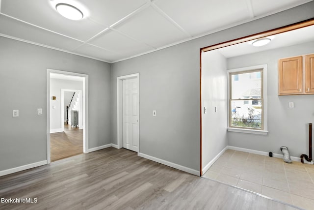 unfurnished room featuring light wood finished floors and baseboards