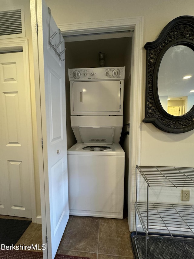 laundry room with stacked washing maching and dryer