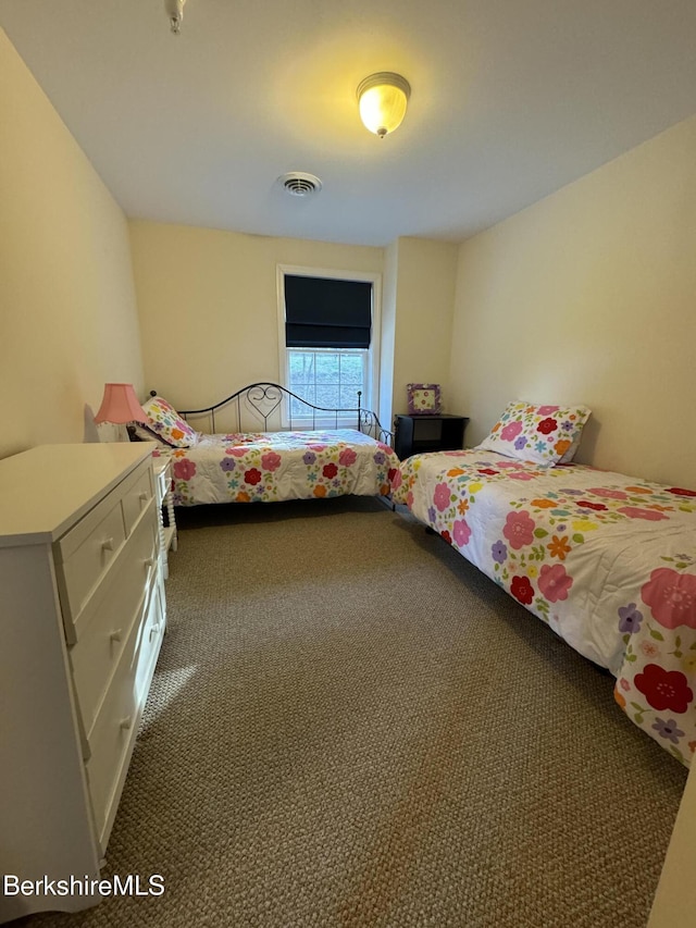 unfurnished bedroom with dark carpet