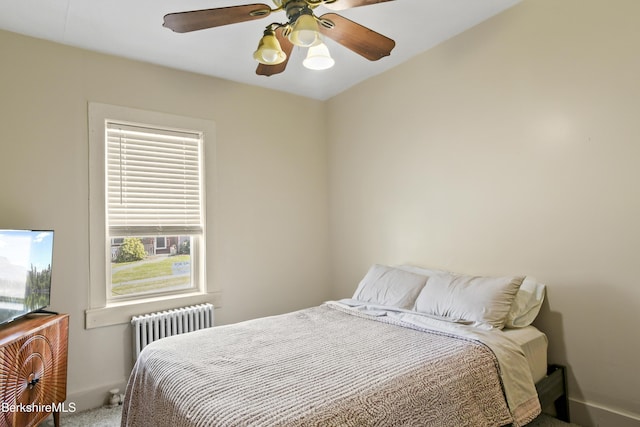 carpeted bedroom featuring radiator and ceiling fan