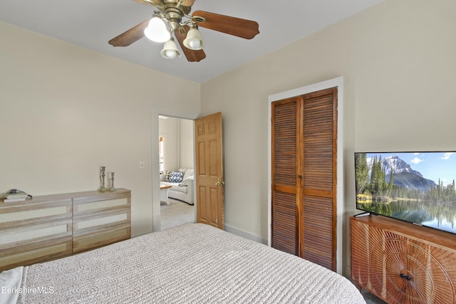 carpeted bedroom with a closet and a ceiling fan