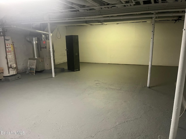 unfinished basement featuring gas water heater