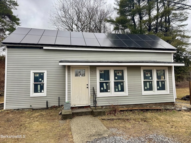 view of front facade with roof mounted solar panels