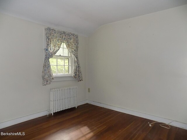 350 Laurel St, Lee, MA 01238 - spare room featuring radiator heating unit, wood finished floors, vaulted ceiling, and baseboards