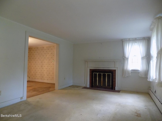 350 Laurel St, Lee, MA 01238 - unfurnished living room featuring a baseboard heating unit, a brick fireplace, and carpet flooring
