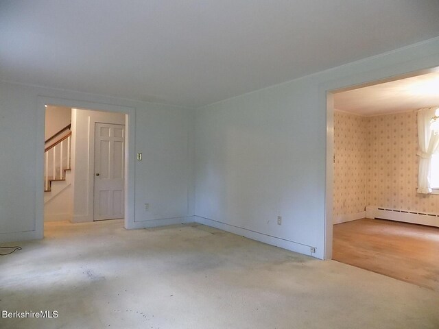 350 Laurel St, Lee, MA 01238 - empty room featuring stairway, a baseboard heating unit, wallpapered walls, and baseboards