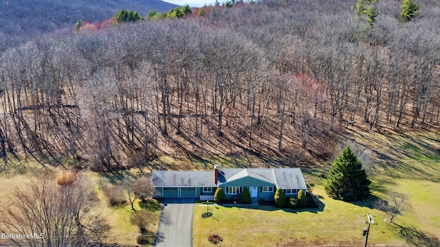 birds eye view of property featuring a view of trees