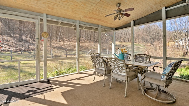 unfurnished sunroom featuring outdoor dining space and a ceiling fan
