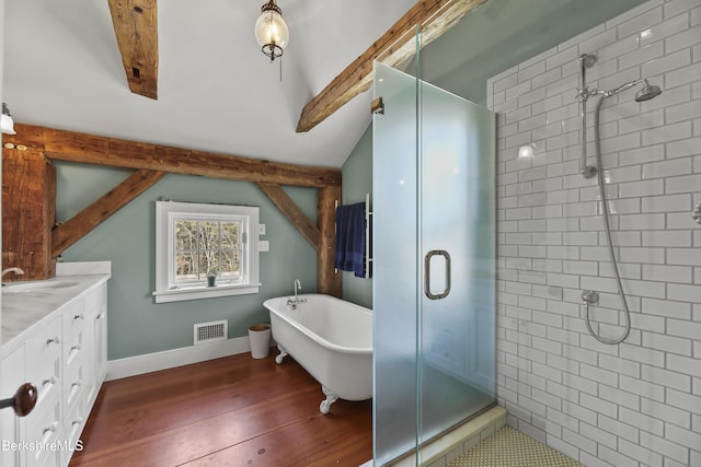 16 Glendale Middle Rd, Stockbridge, MA 01262 - bathroom featuring a shower stall, double vanity, a freestanding bath, wood finished floors, and baseboards
