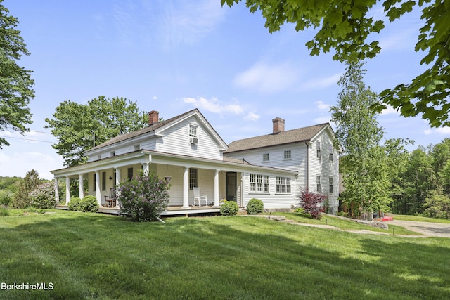 16 Glendale Middle Rd, Stockbridge, MA 01262 - view of front facade with a chimney, covered porch, a front lawn, and roof with shingles