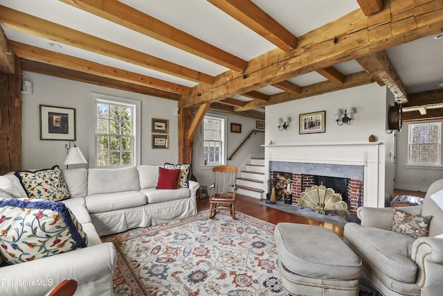 16 Glendale Middle Rd, Stockbridge, MA 01262 - living area with beam ceiling, stairs, wood finished floors, and a fireplace with flush hearth