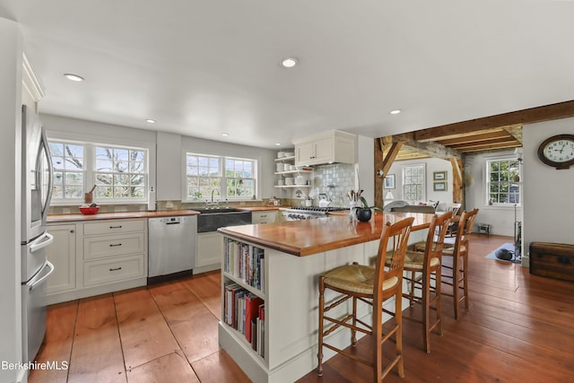 16 Glendale Middle Rd, Stockbridge, MA 01262 - kitchen with stainless steel dishwasher, wooden counters, open shelves, a sink, and a kitchen breakfast bar