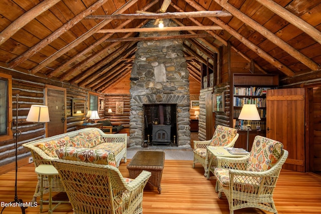 411 Bressett Rd, Williamstown, MA 01267 - living room with wood ceiling with exposed beams, a wood stove, hardwood / wood-style floors, rustic walls, and high vaulted ceiling