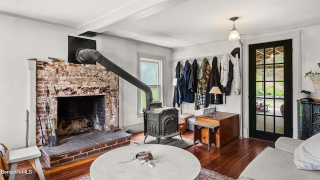 32 S Main Rd, Otis, MA 01253 - living room featuring a wood stove, hardwood / wood-style floors, beamed ceiling, ornamental molding, and a fireplace