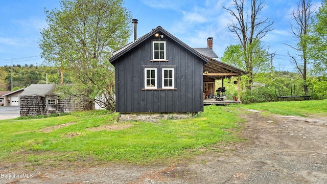 32 S Main Rd, Otis, MA 01253 - view of home's exterior with board and batten siding and a chimney