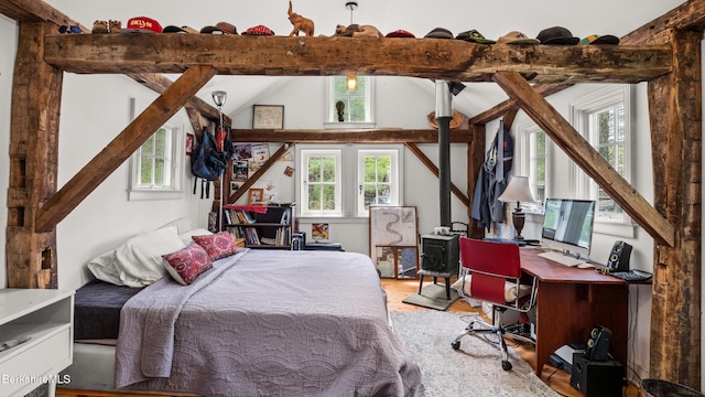 32 S Main Rd, Otis, MA 01253 - bedroom featuring multiple windows, wood finished floors, a wood stove, and a desk