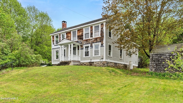 32 S Main Rd, Otis, MA 01253 - view of front of house featuring a chimney, a front yard, and an outdoor structure